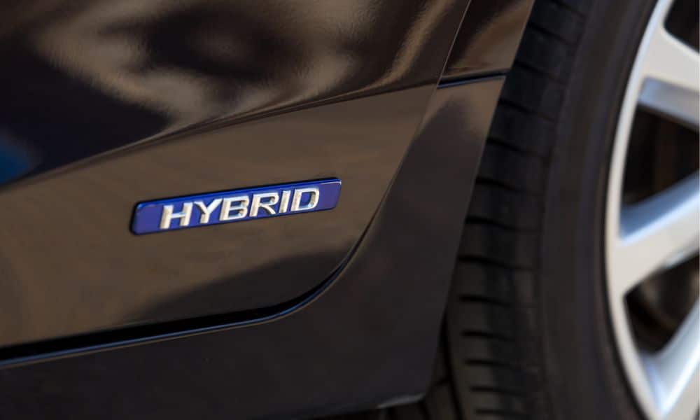 A close up of the Hybrid logo on a hybrid car