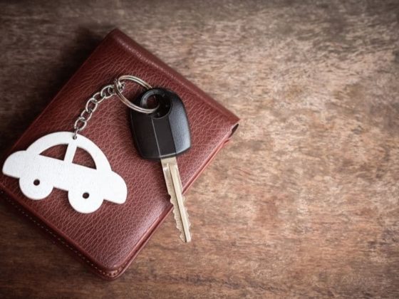 Car keys and a car keyring sit on a leather wallet