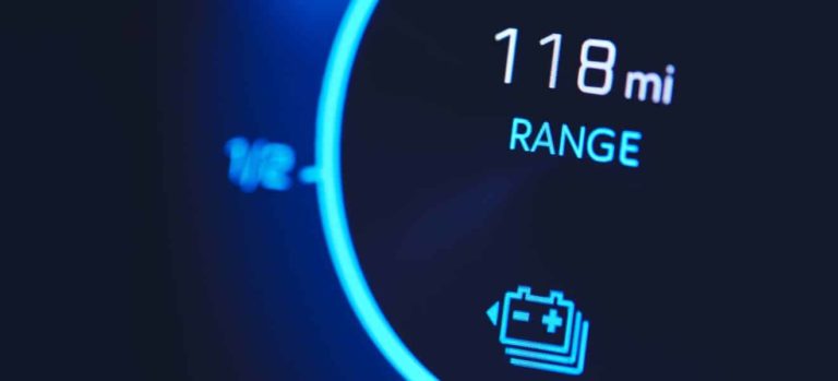 An EV dash reading shows a battery range of 118 miles